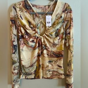 Brand new multi color blouse. From the buckle. Criss cross neckline.